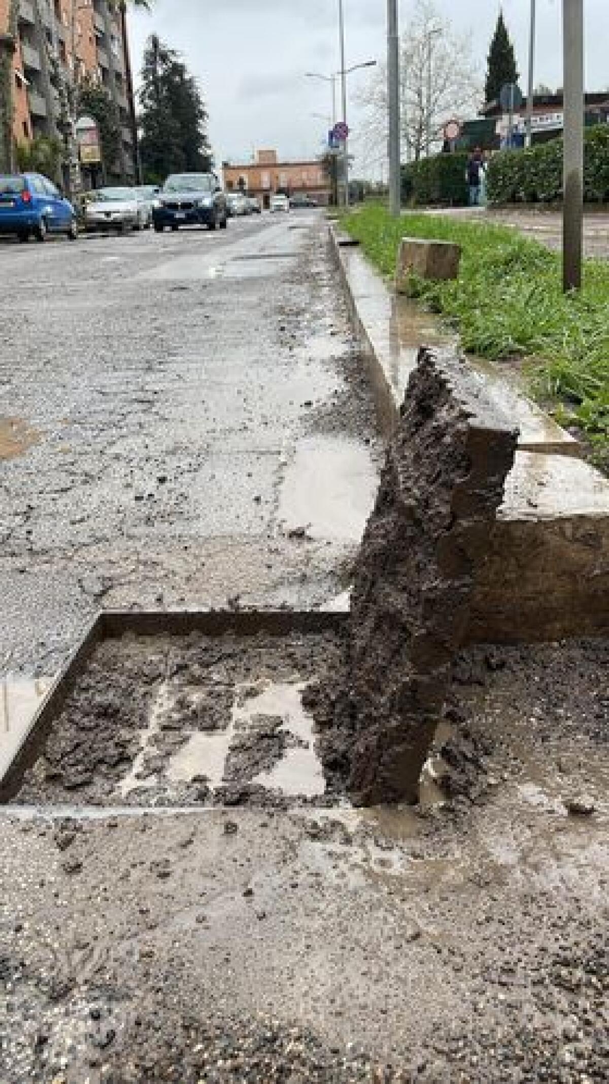 Aprilia - Fango e detriti nei tombini di via Inghilterra, puliscono i commercianti: "Zero interventi dal Comune" - 